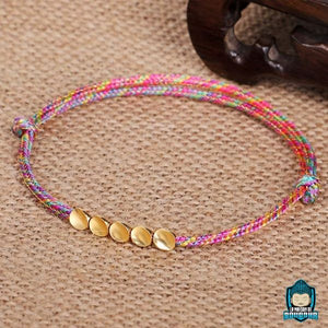 Bracelet-Tresse-Tibetain-Rouge-et-Perles-de-Cuivre-Arc-en-Ciel-5-perles-La-Maison-de-Bouddha