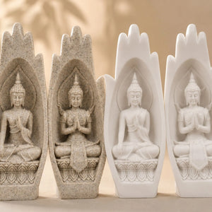 Gros plan sur les deux figures de Bouddha sculptées dans les mains décoratives en résine