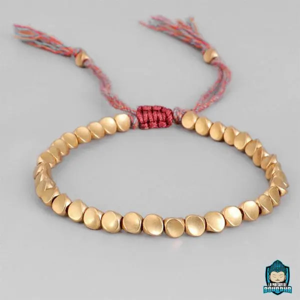 Bracelet tibétain en perles de cuivre dorées avec fermeture en cordon tressé