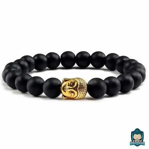 Bracelet-Bouddha-Pierre-de-Lave-medaillon-tete-de-Bouddha-dore-perles-de-couleur-noires-mates-sur-fond-blanc-La-Maison-de-Bouddha